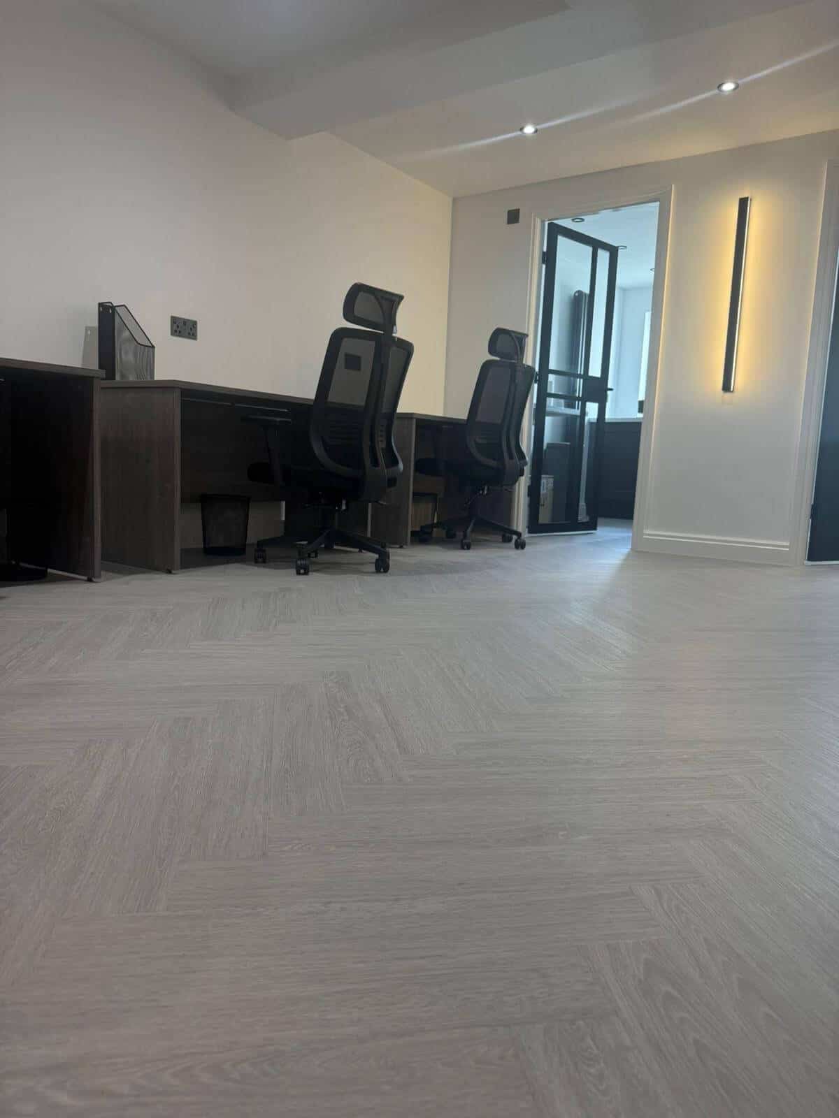 Light grey LVT herringbone flooring installed in a modern office space by Banks Flooring Solutions